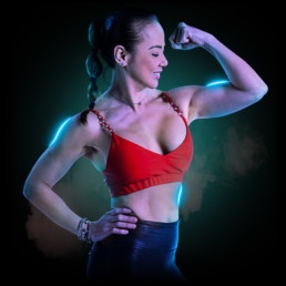BMF Co-founder, Margaux Phoenix, flexing her biceps.